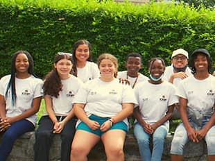A group of teenagers smiling in a group photo